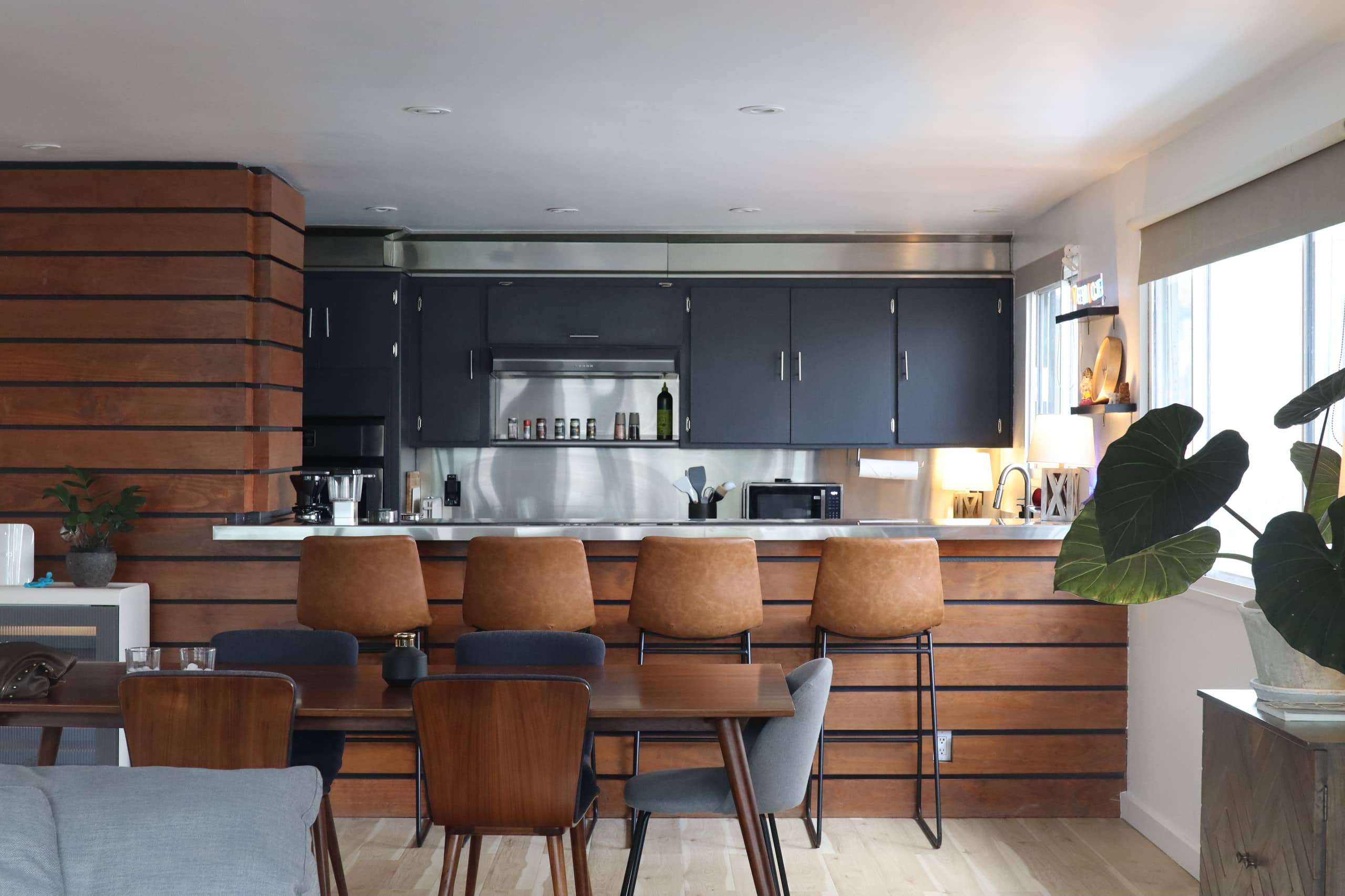 Kitchen with dark cabinetry and a wood island